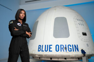 Aisha Bowe in front of the Blue Origin Spacecraft