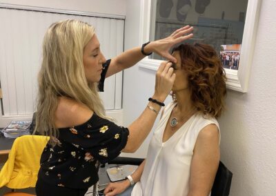 Hair and Makeup Artist, Bridget Elam, applying makeup to Jane prior to the live streaming press conference